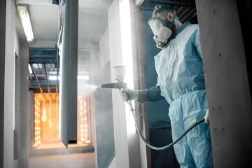 Technician performing quality inspection on powder coated industrial parts