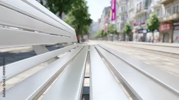 Technician applying powder coating to metal furniture frame