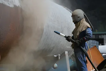 Close-up of properly profiled metal surface after precision sandblasting showing anchor pattern