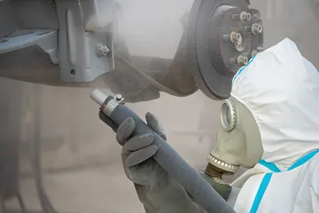 Step-by-step automotive sandblasting process showing before and after results