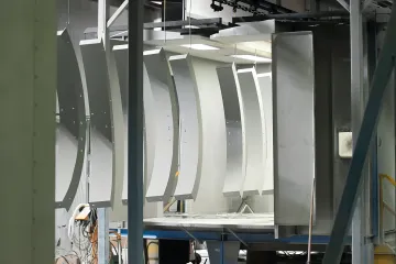 Automotive parts moving through multi-stage surface treatment process