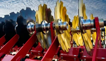 Powder coated agricultural equipment parts showing durable finish