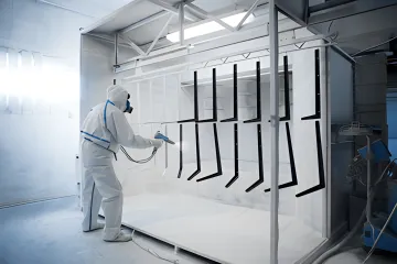 Industrial powder coating process showing surface preparation and application stages