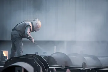 Close-up of metal surface showing proper anchor profile after professional sandblasting