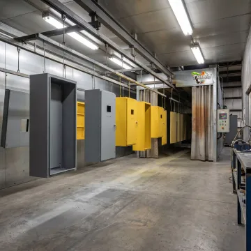 Powder coated electrical control cabinets in an industrial finishing facility