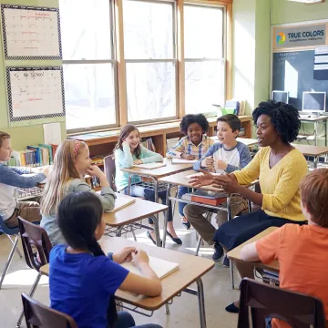 Teacher leading an engaged classroom discussion