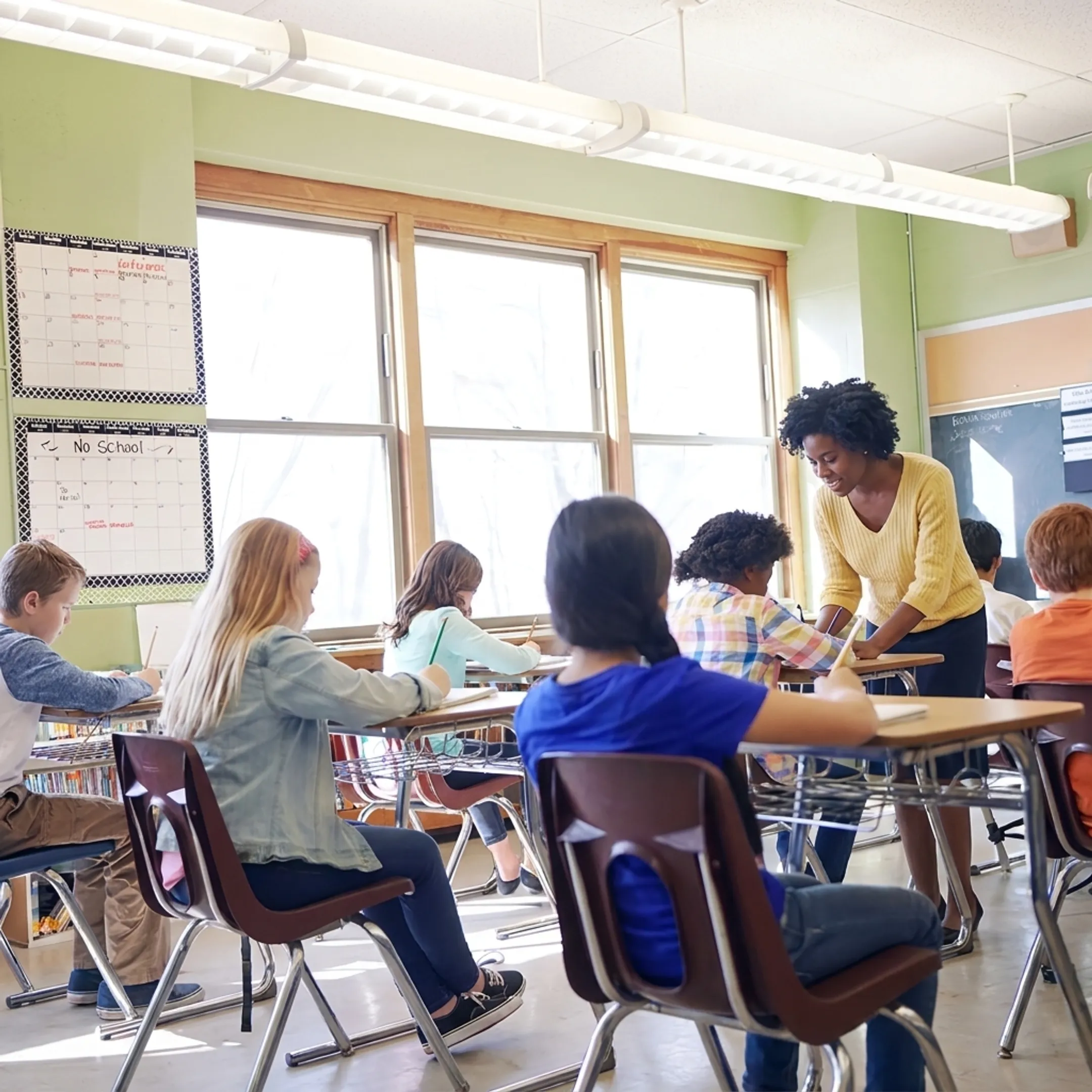 Teacher engaging with elementary school students using supportive emotional intelligence strategies
