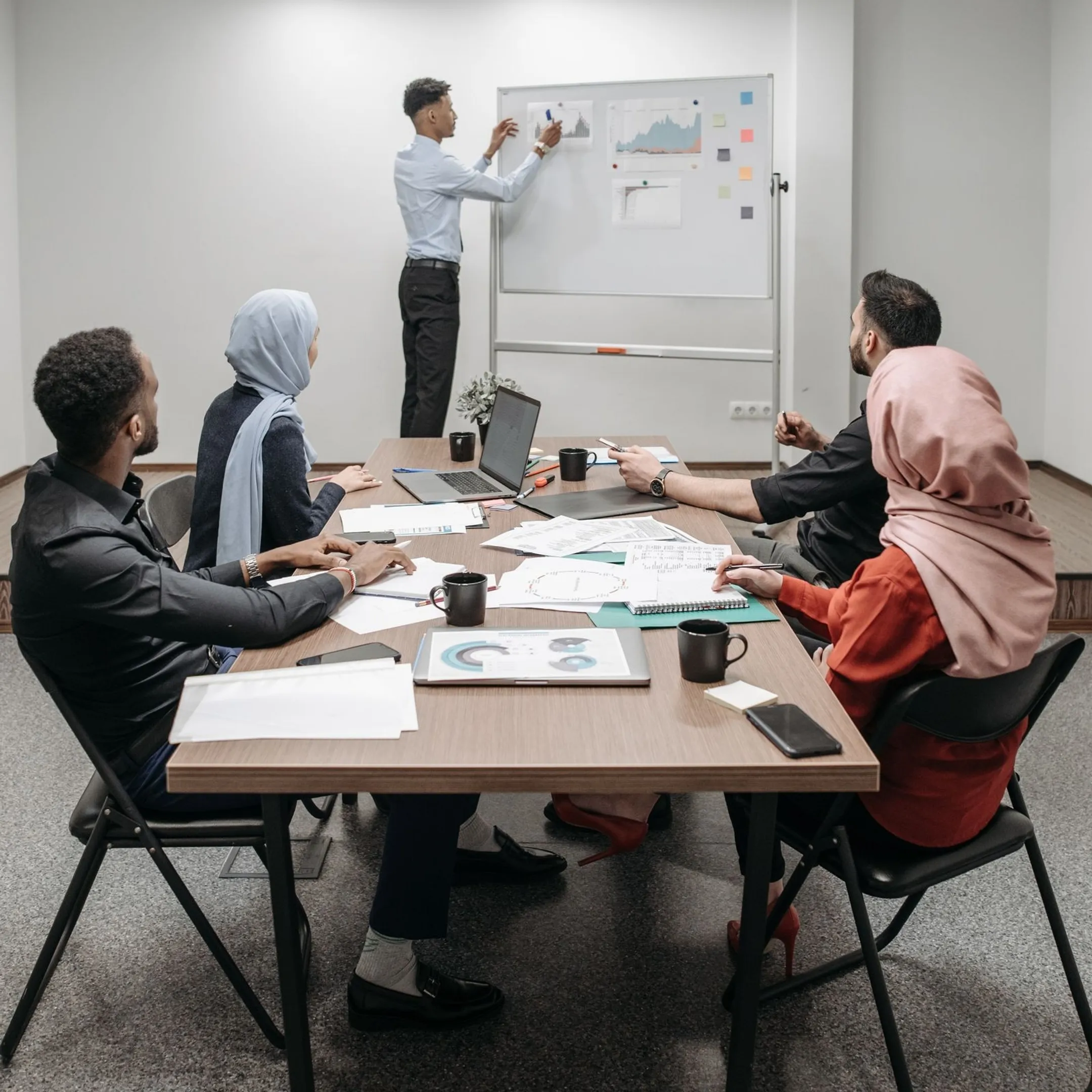 Academic leaders discussing conflict management strategies in a university boardroom