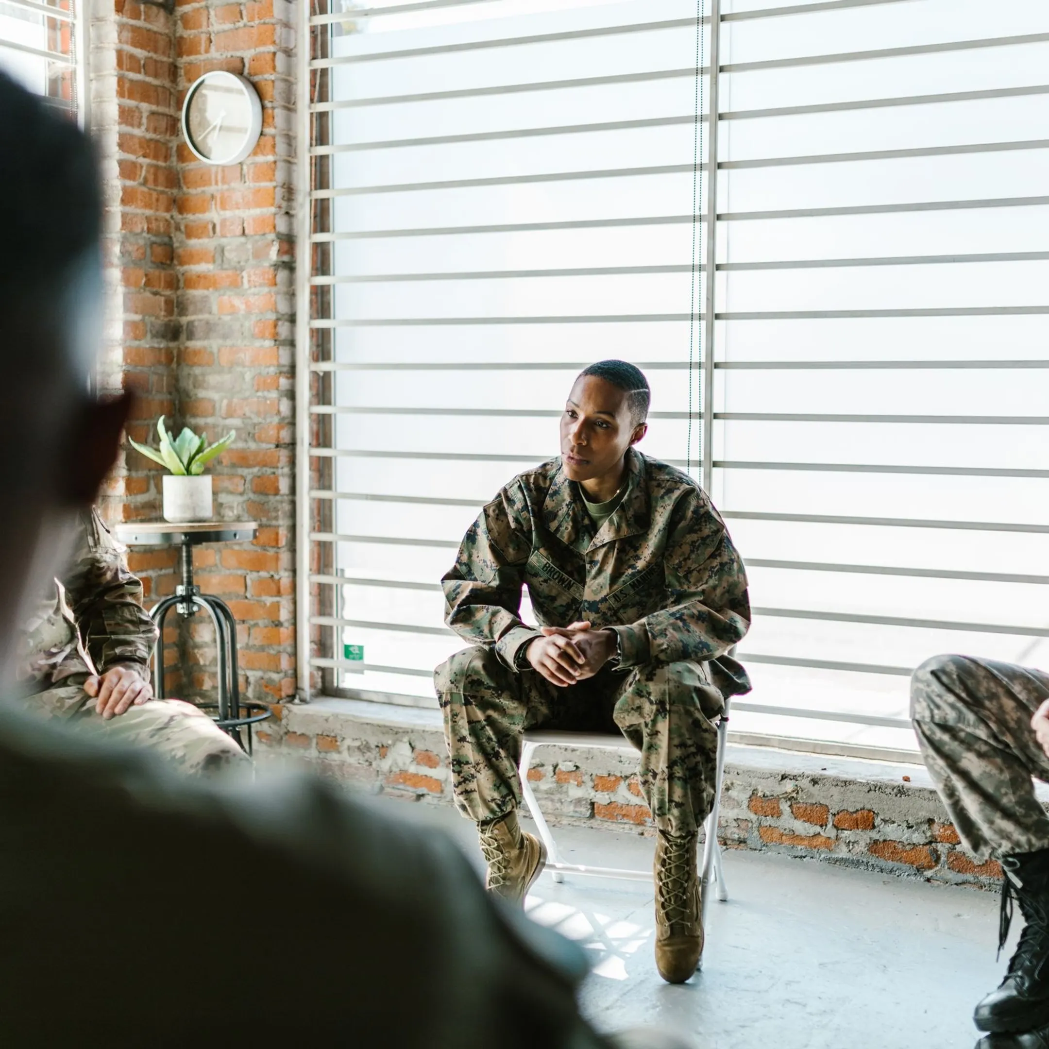Military leaders collaborating around a briefing table during leadership development training