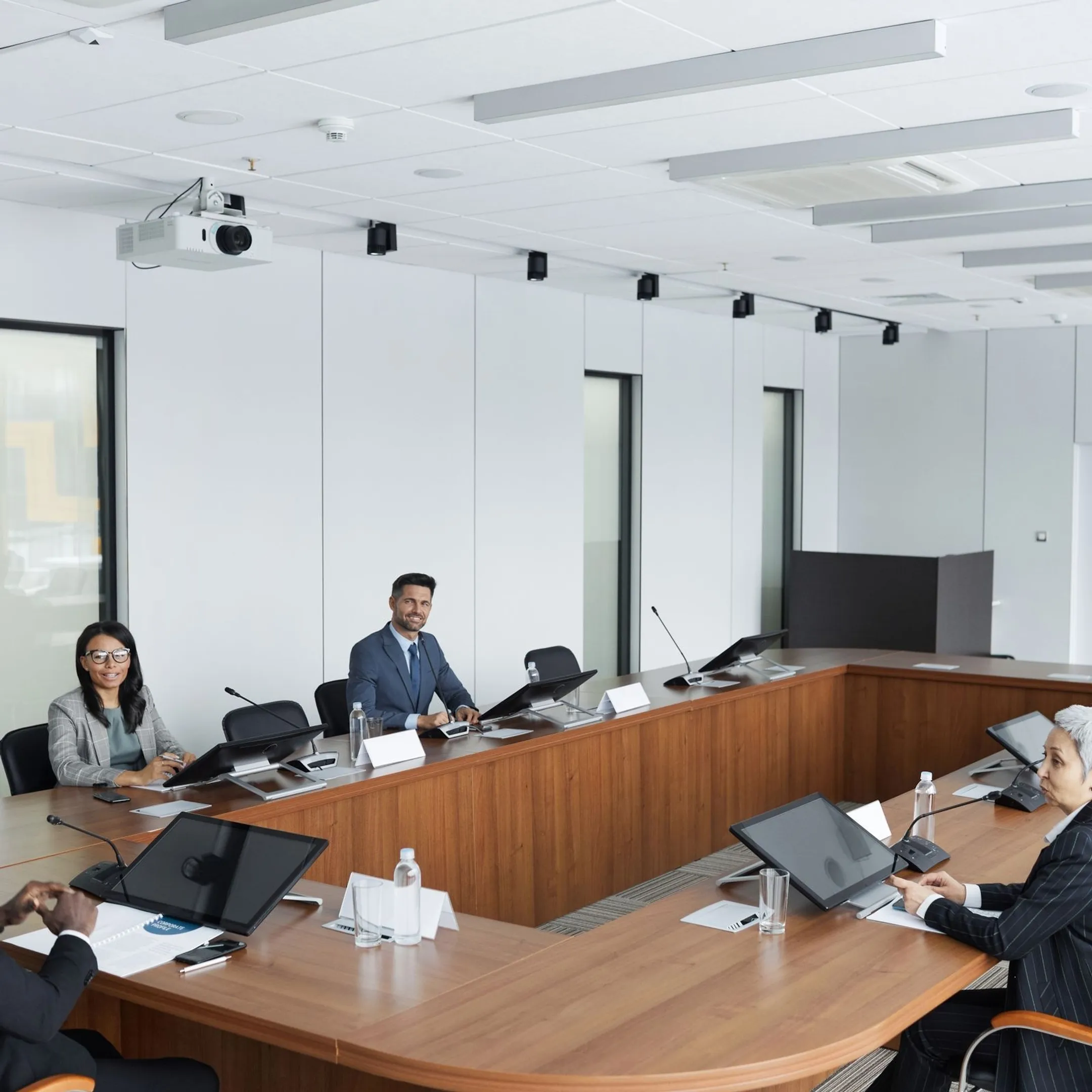 Executive team collaborating in a corporate boardroom during a leadership session