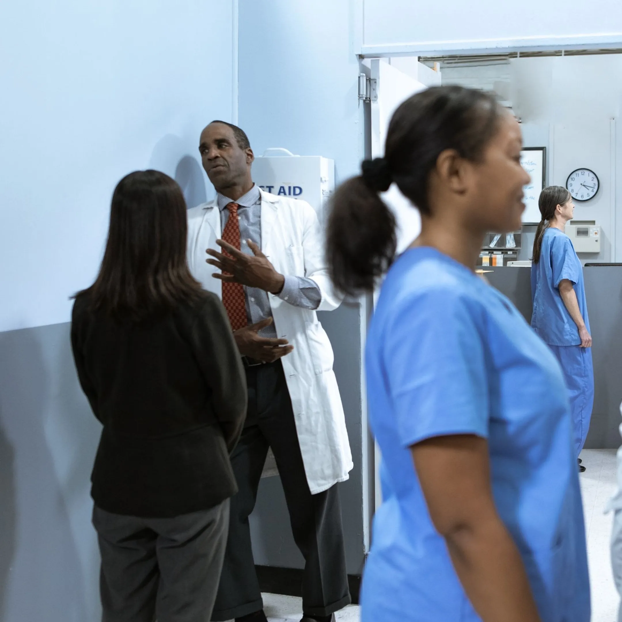 Nurse team discussing patient care collaboration in a hospital hallway