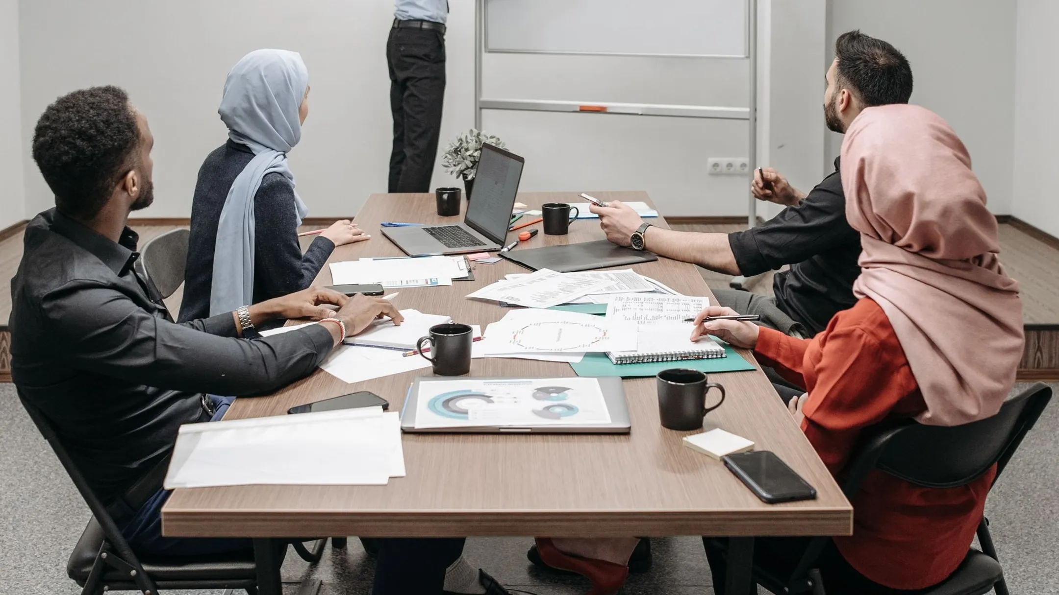 Hybrid team members participating in collaborative in-person team building activity