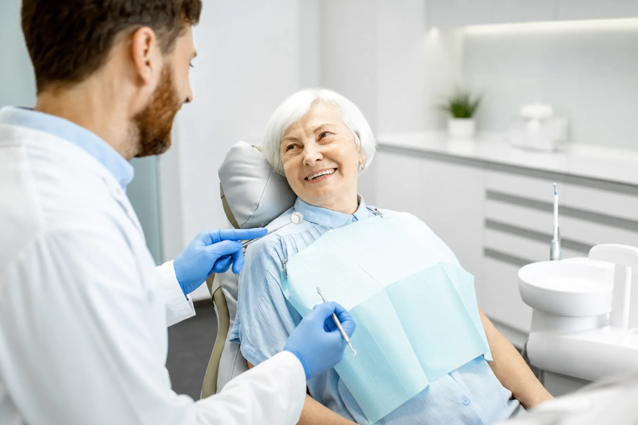 Senior couple smiling during dental checkup at dentist office