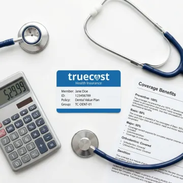 Dental insurance card and coverage documents with calculator showing affordable rates