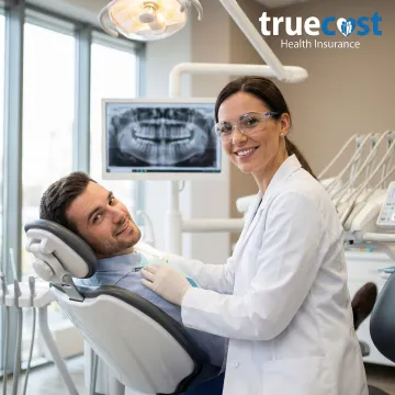 Dentist examining patient with modern dental equipment
