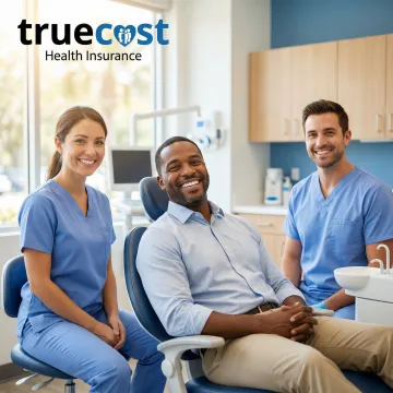 Florida resident smiling during dental checkup covered by insurance