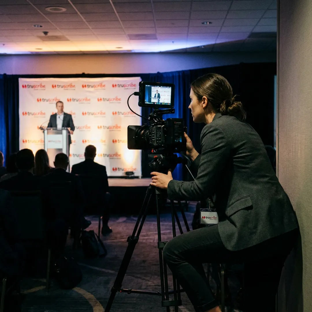 Corporate event videography team filming a speaker