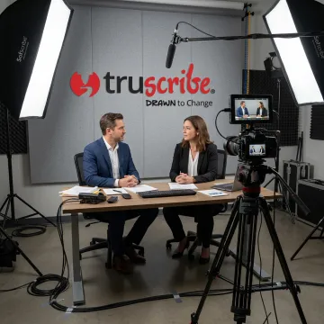 Video production team filming a professional interview