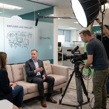 Documentary video crew filming an executive interview