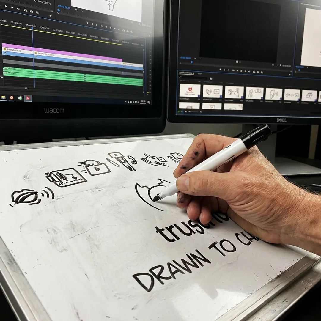 Artist creating a hand-drawn whiteboard animation sequence