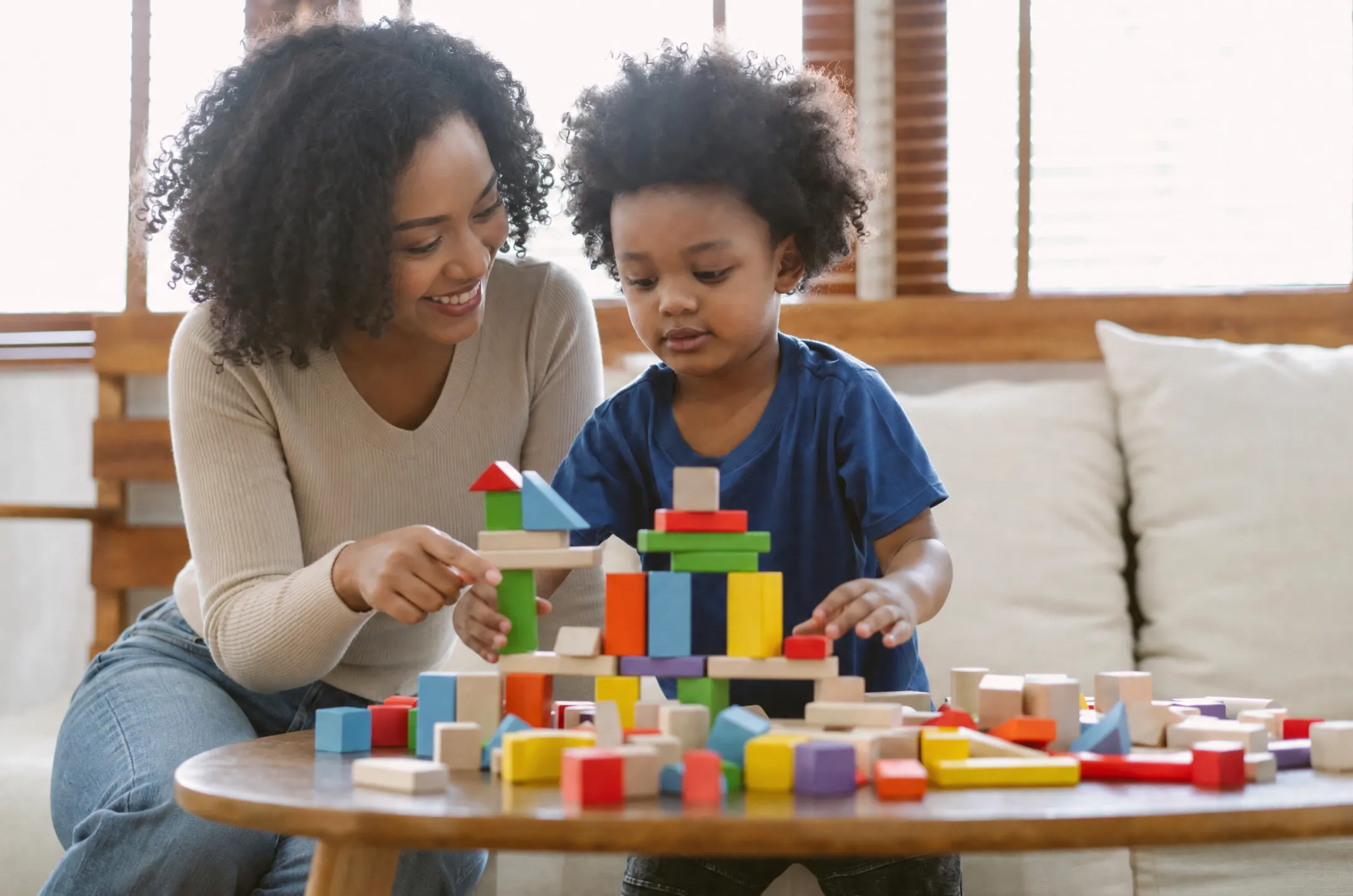 Preschooler engaged in guided play with blocks and sensory materials