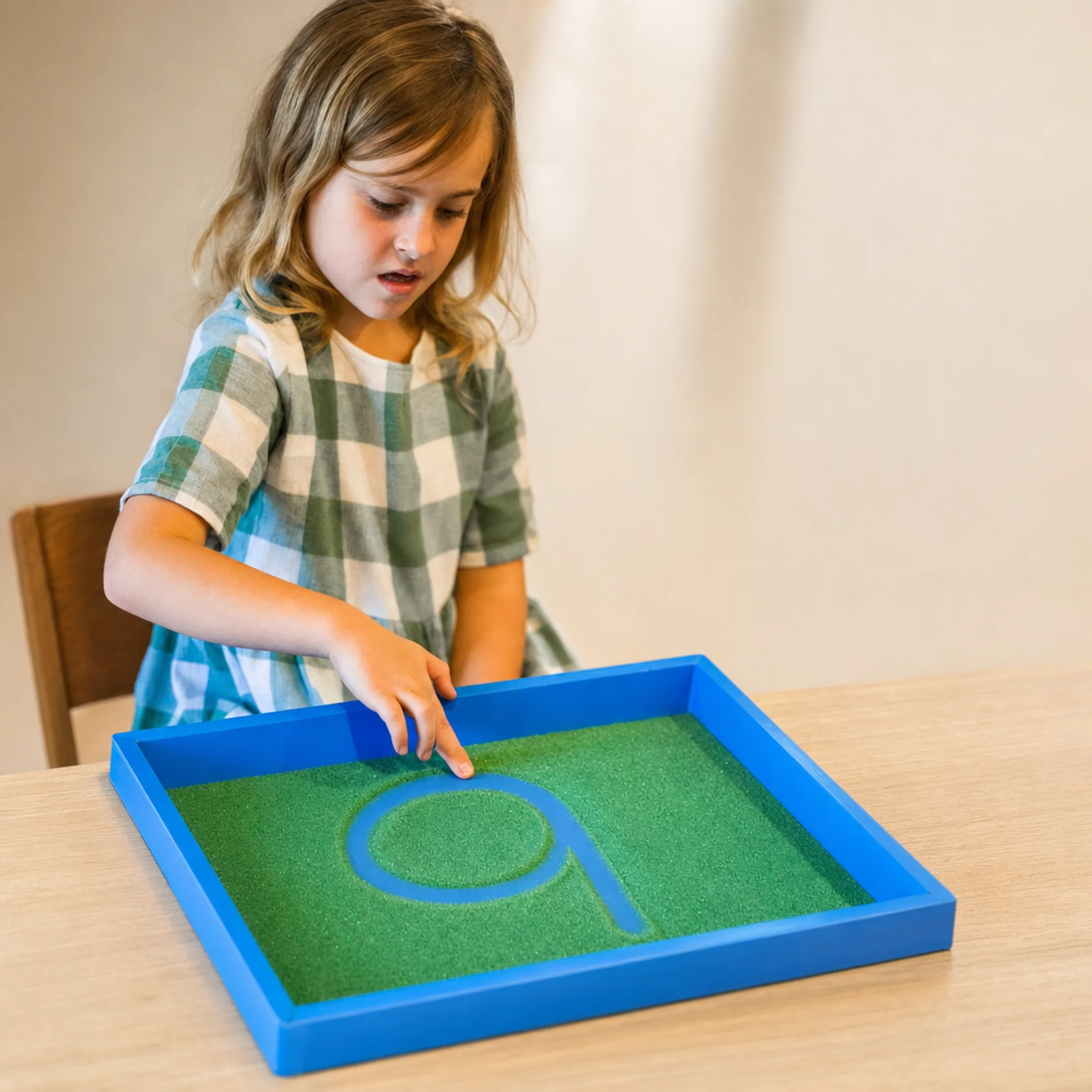 Child practicing multisensory letter tracing for dysgraphia support
