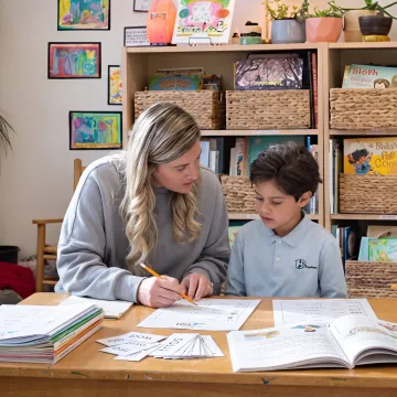 Homeschool parent using language arts curriculum materials