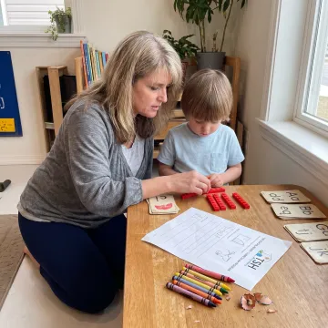 Kindergartener completing a hands-on homeschool lesson