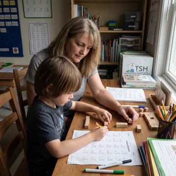 Elementary learner using hands-on math materials