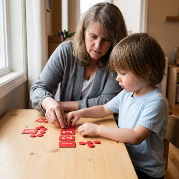 Child using hands-on materials during a home math lesson