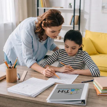Homeschool parent guiding a child through a hands-on lesson