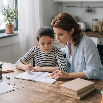 Parent and child completing a practical homeschool lesson