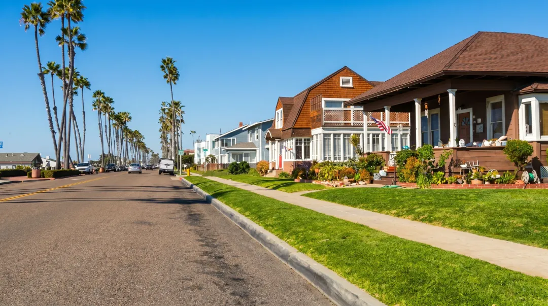 Los Angeles residential neighborhood street showing homes with updated versus outdated exteriors