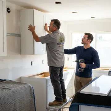 Custom kitchen remodeling contractors installing cabinets