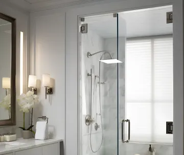 Bathroom remodeler installing tile in a home bathroom