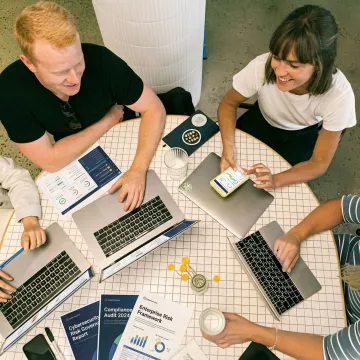 Business executives collaborating on cybersecurity strategy and risk management frameworks