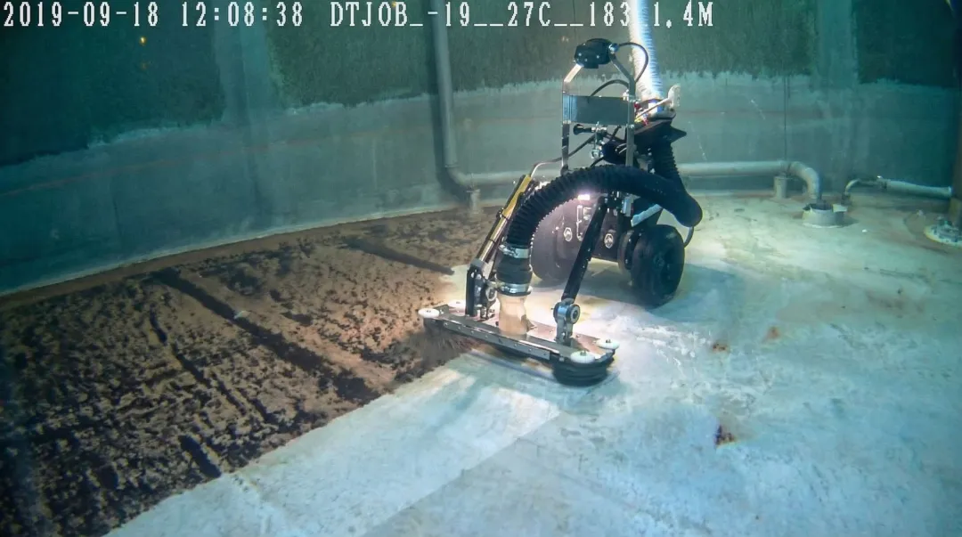 Remotely operated underwater cleaning robot inspecting potable water reservoir tank interior