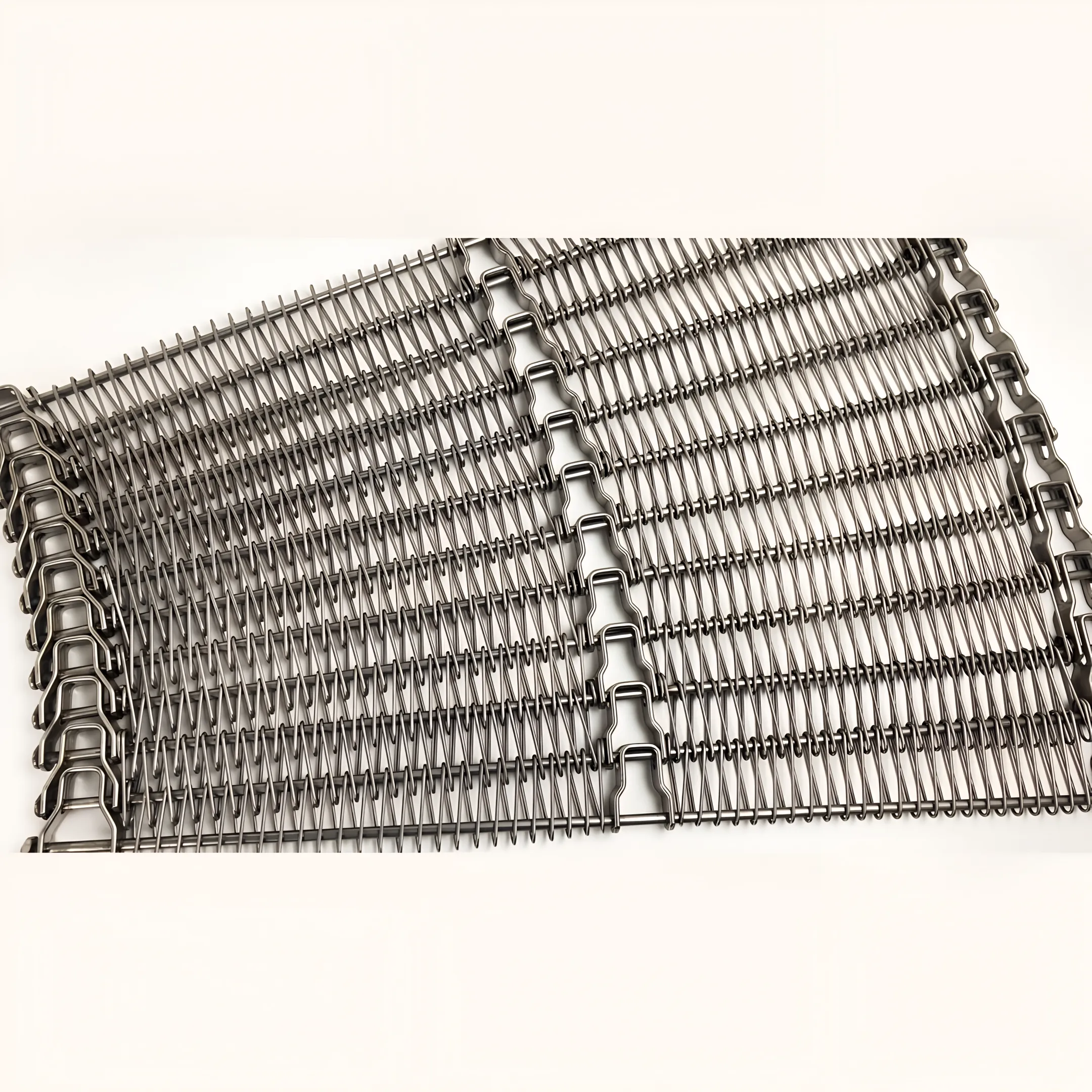 Wire mesh conveyor belt carrying baked goods