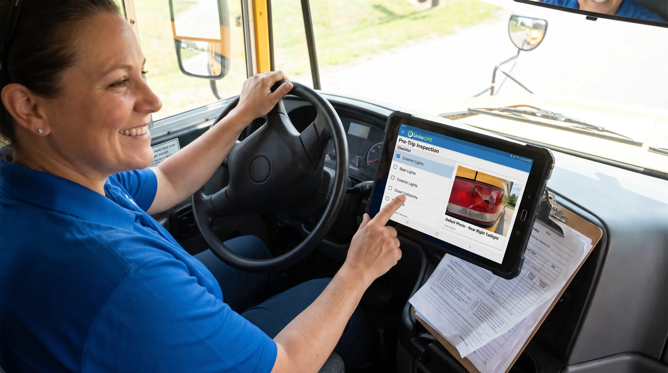 Driver completing tablet-based pre-trip inspection with photo attachment feature
