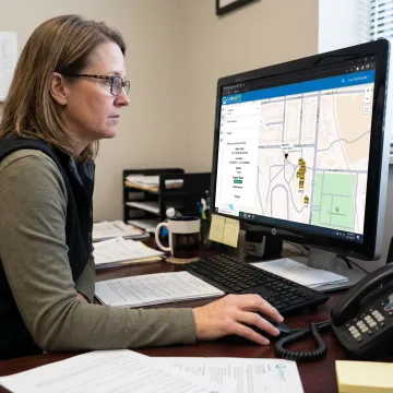 School transportation coordinator viewing live bus routes