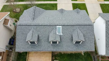 Aerial satellite imagery of residential property rooftop used for AI insurance underwriting assessment