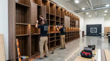 Utah Closet Connection licensed contractors installing custom commercial floor-to-ceiling cabinet system