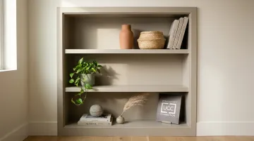 Styled living room shelves with odd-number groupings plants and mixed texture objects