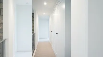 Slim built-in hallway cabinet in narrow corridor with open walkway clearance