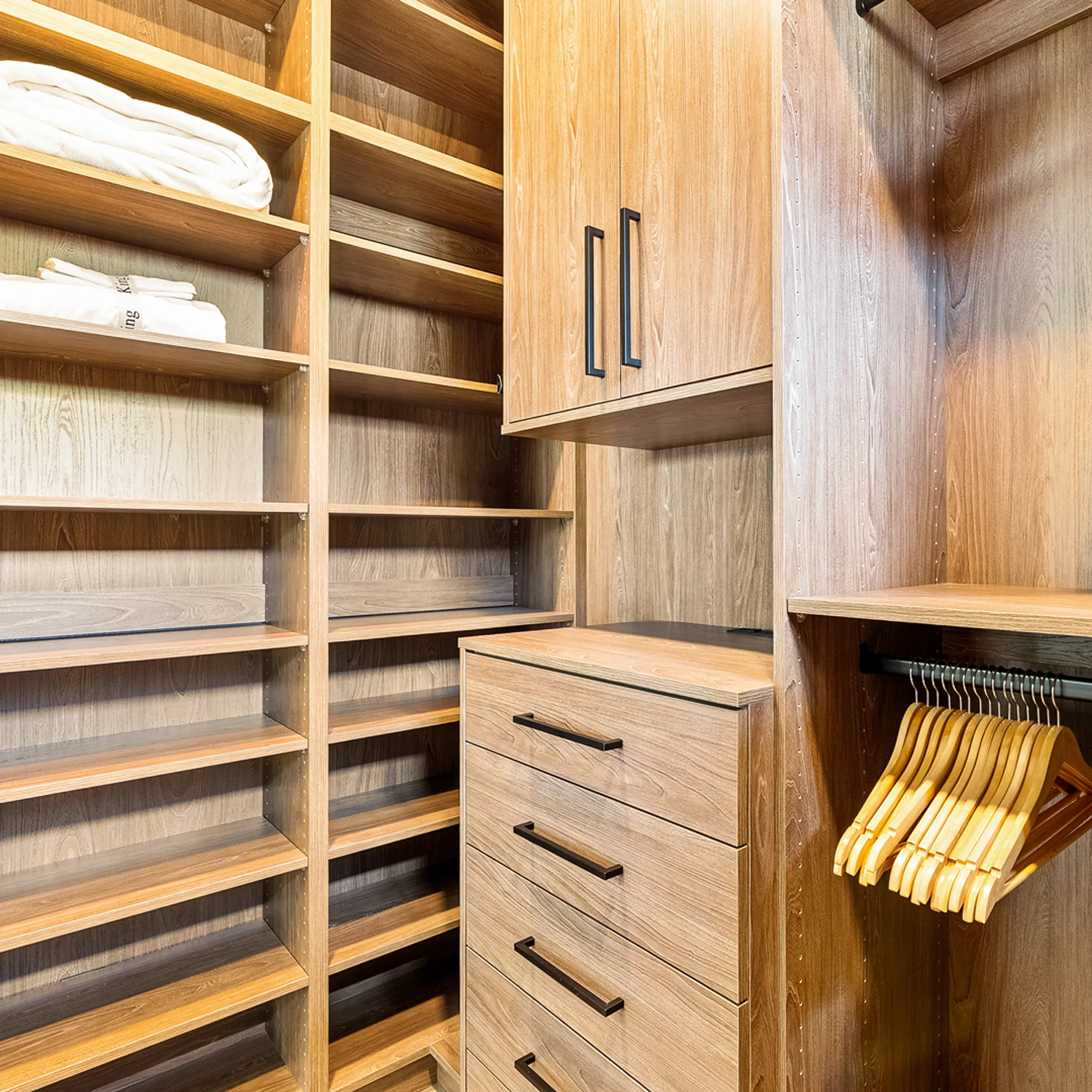 Organized custom closet system with shelving and drawers