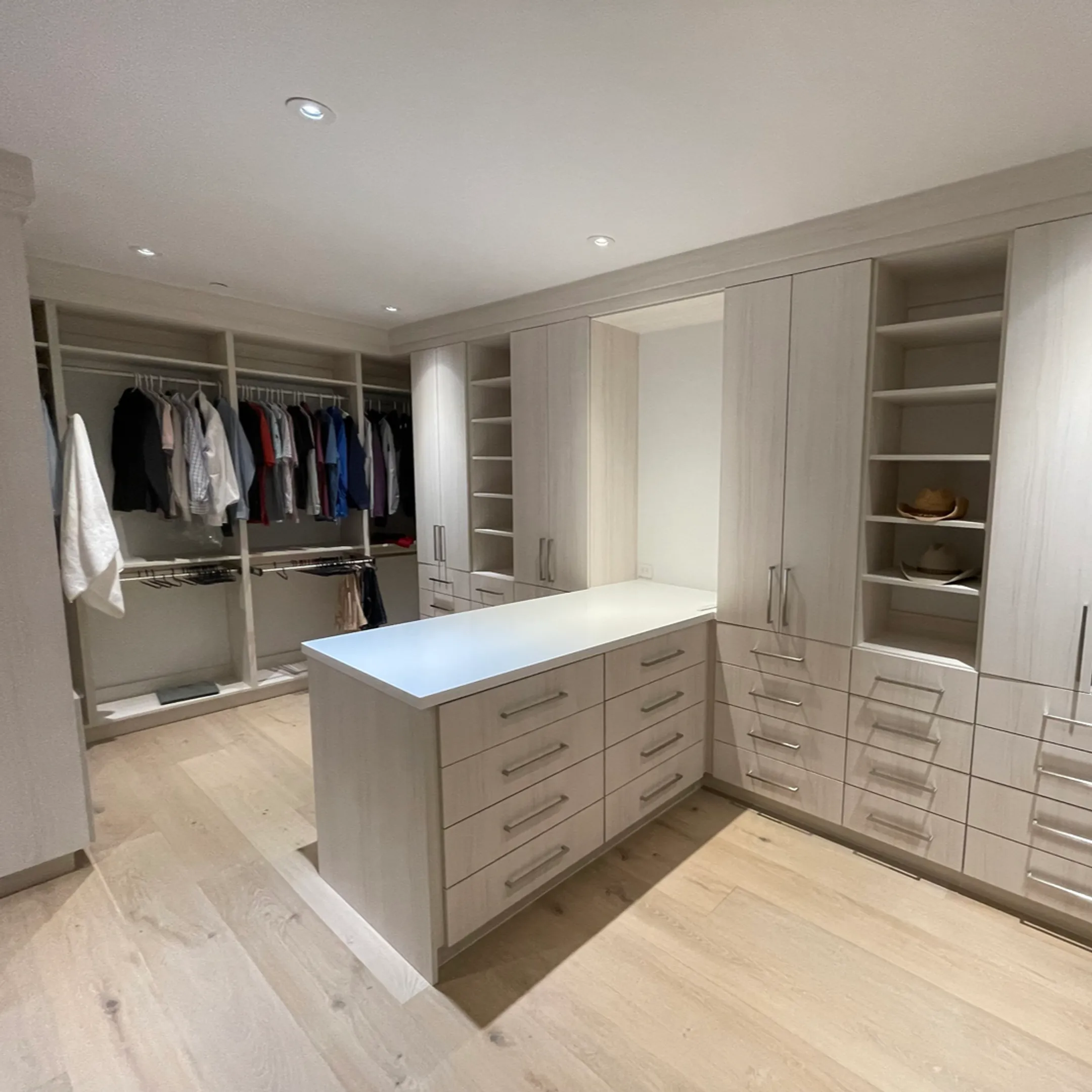 Custom walk-in closet with organized shelves and drawers