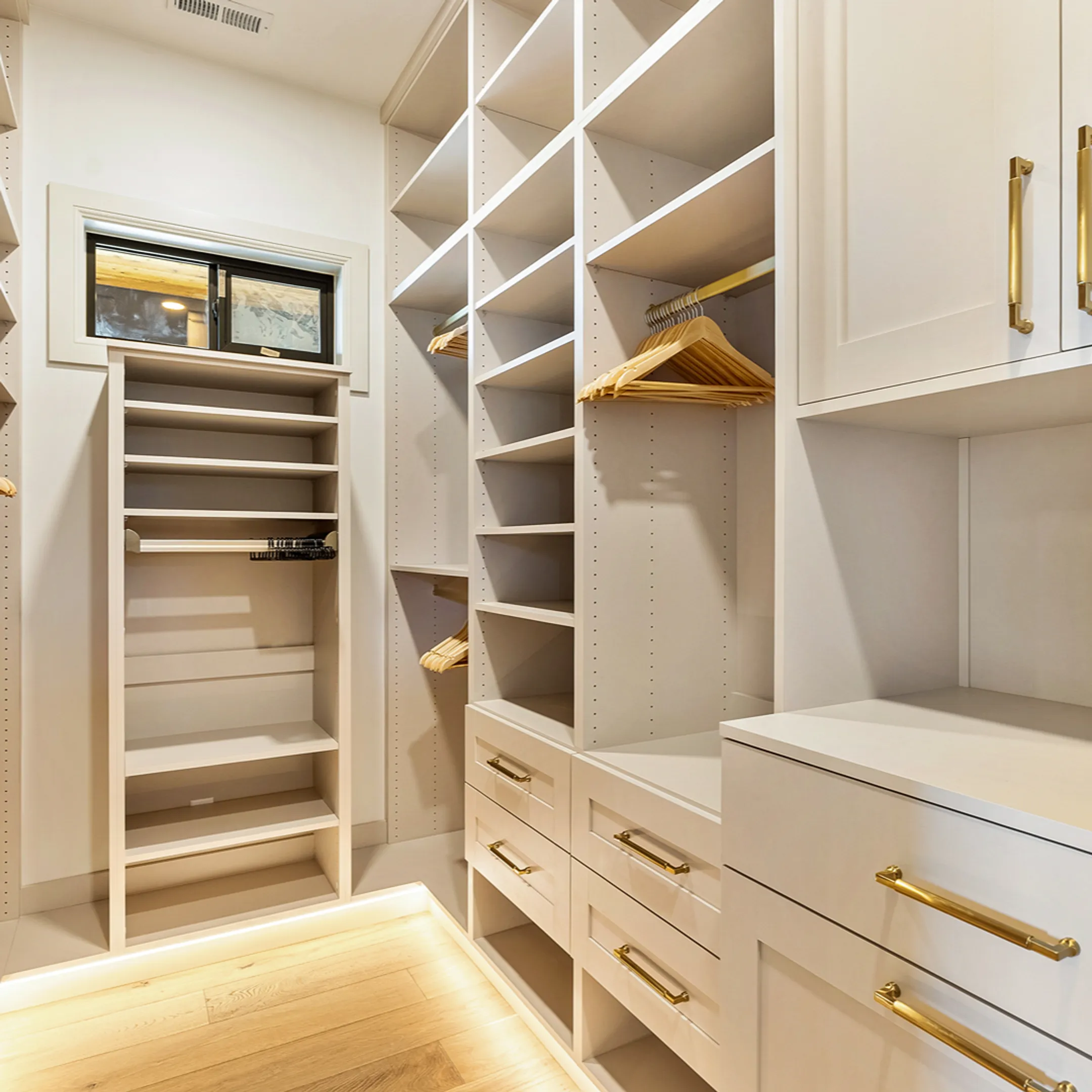 Custom organized walk-in closet with shelving and drawers