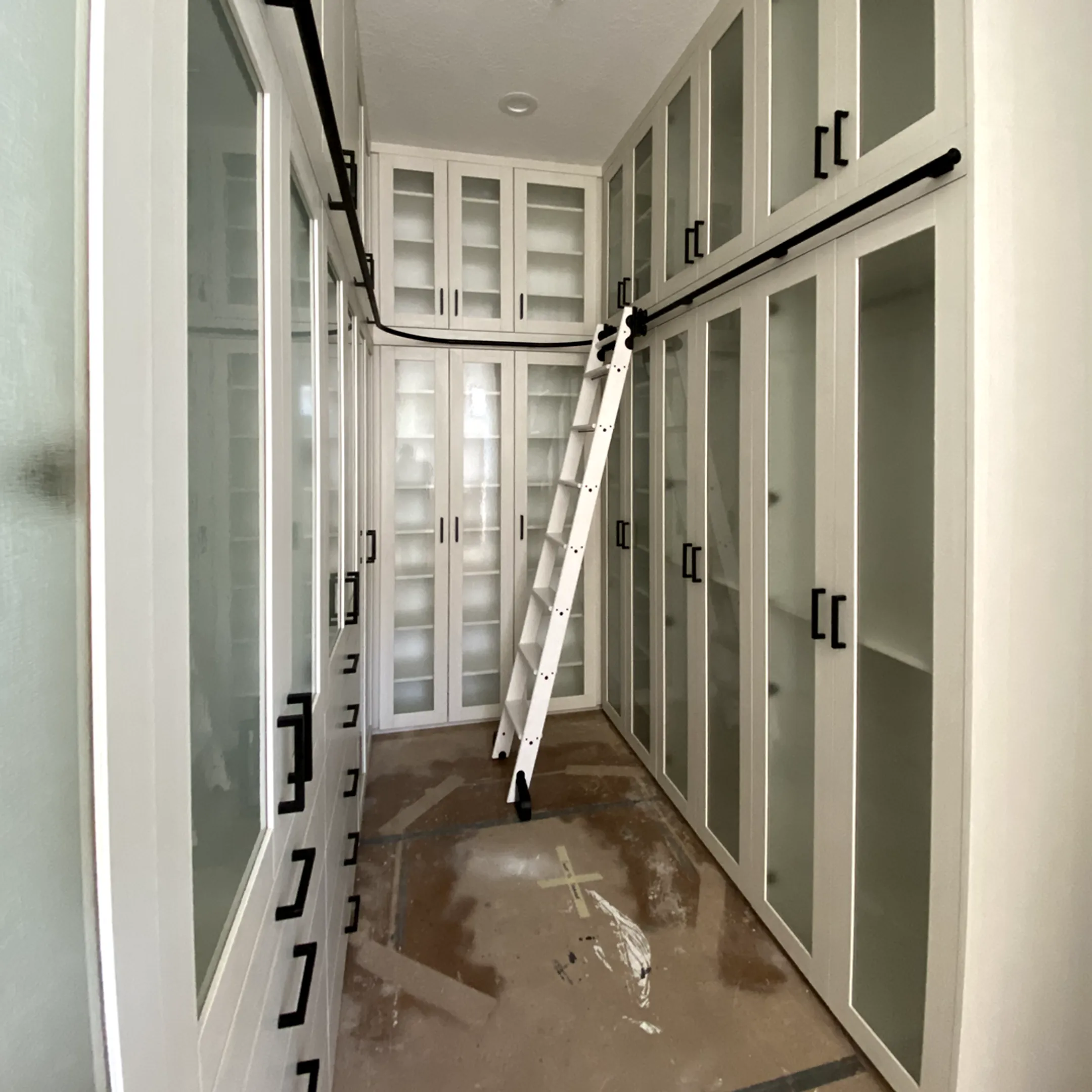 Installer measuring wall bed cabinetry