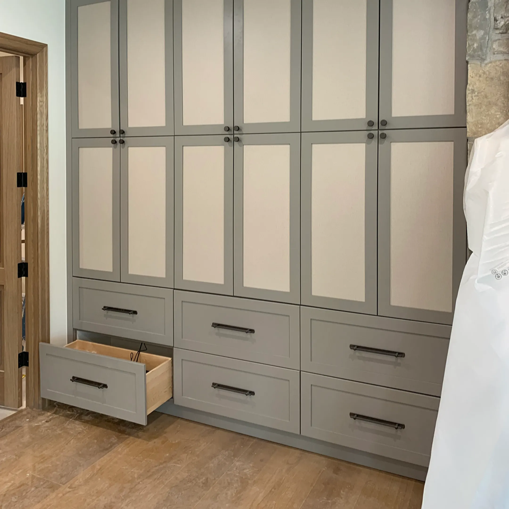 Installer fitting a custom Murphy bed into built-in cabinetry