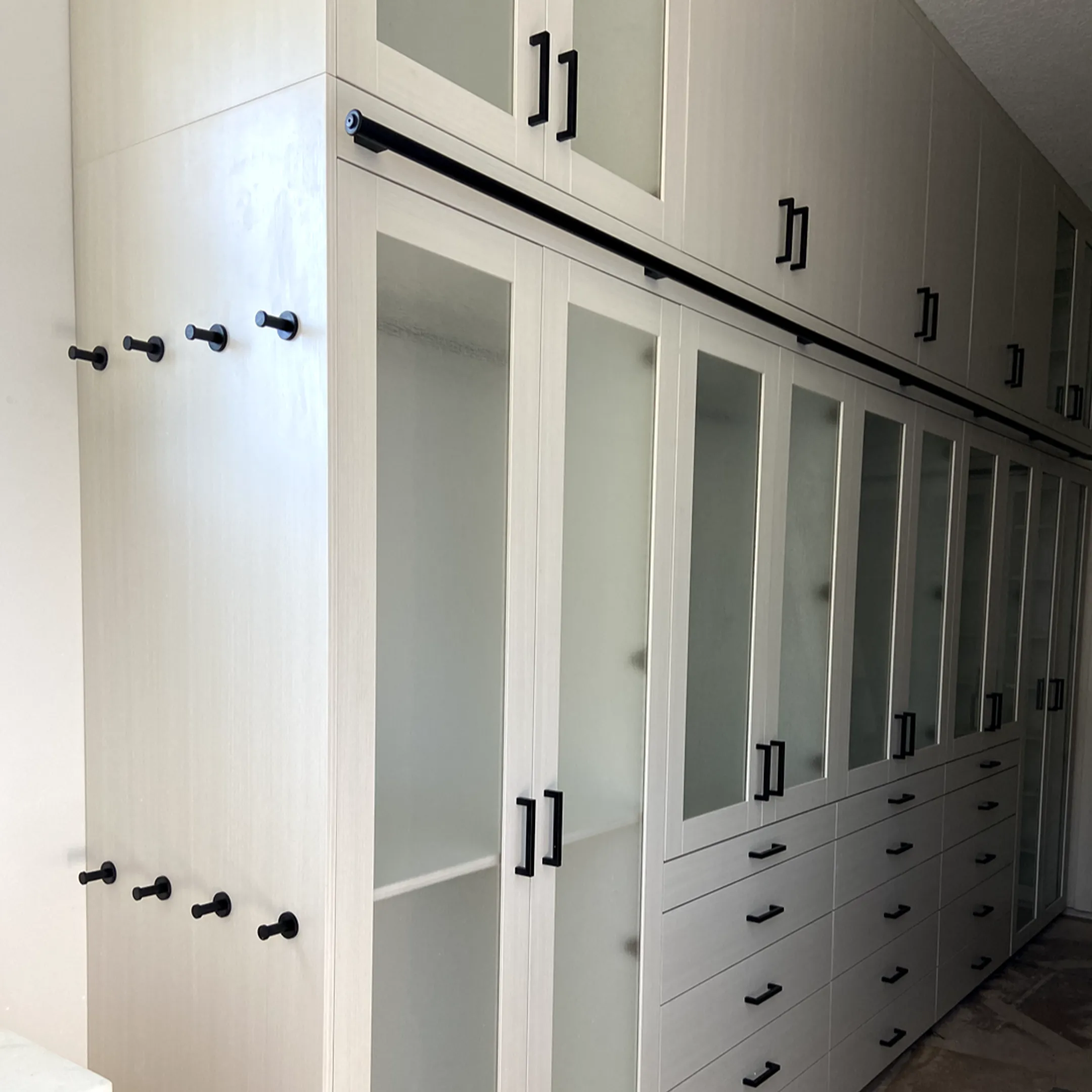 Installer fitting a custom hidden bookcase door